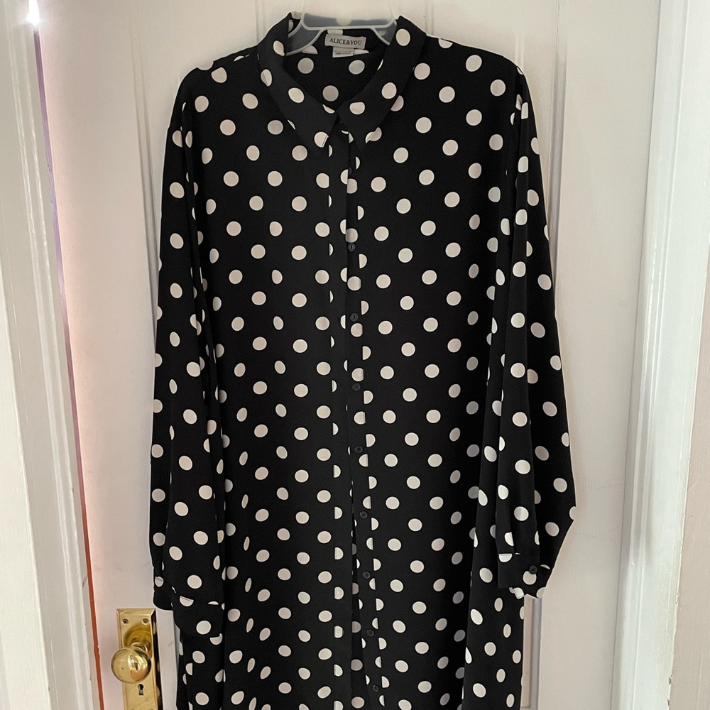 Super cute black and white pok-a-dot blouse worn as a dress with white belt.